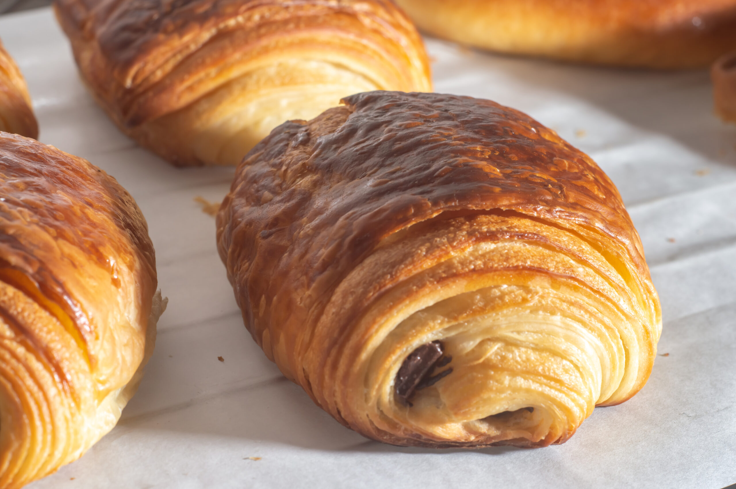 Freshly backed french traditional croissant chocolate - petit pain au chocolat shiny in the rays of the morning sun. Mühlviertler Kreuzhebemeisterschaft 2021